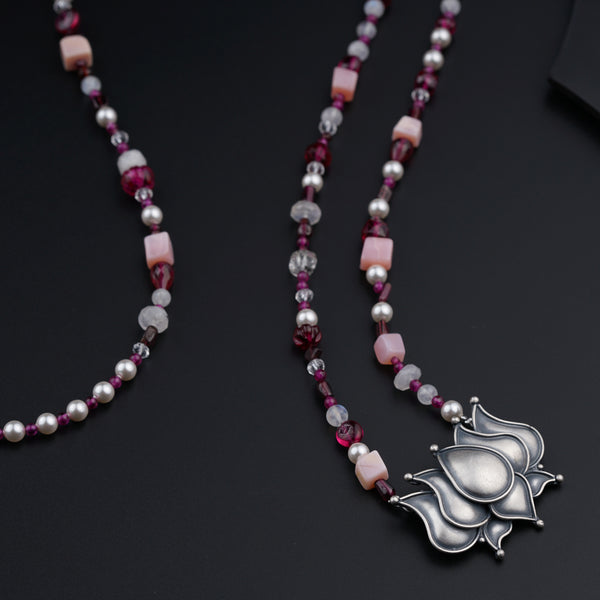a long necklace with a flower design on it