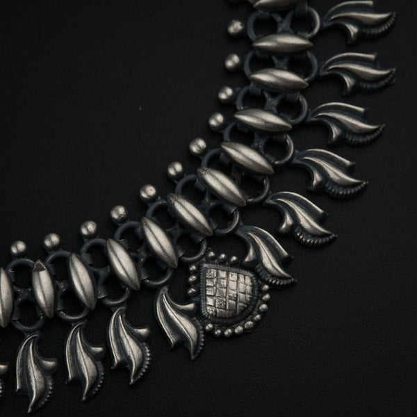 a close up of a necklace on a black surface
