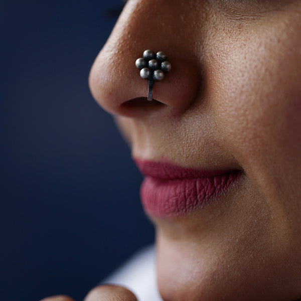 a close up of a person with a nose piercing