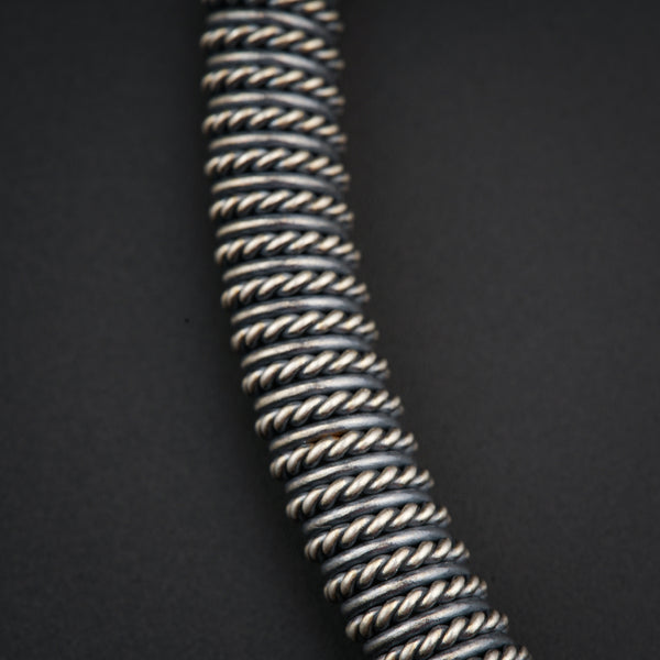 a close up of a metal object on a black surface