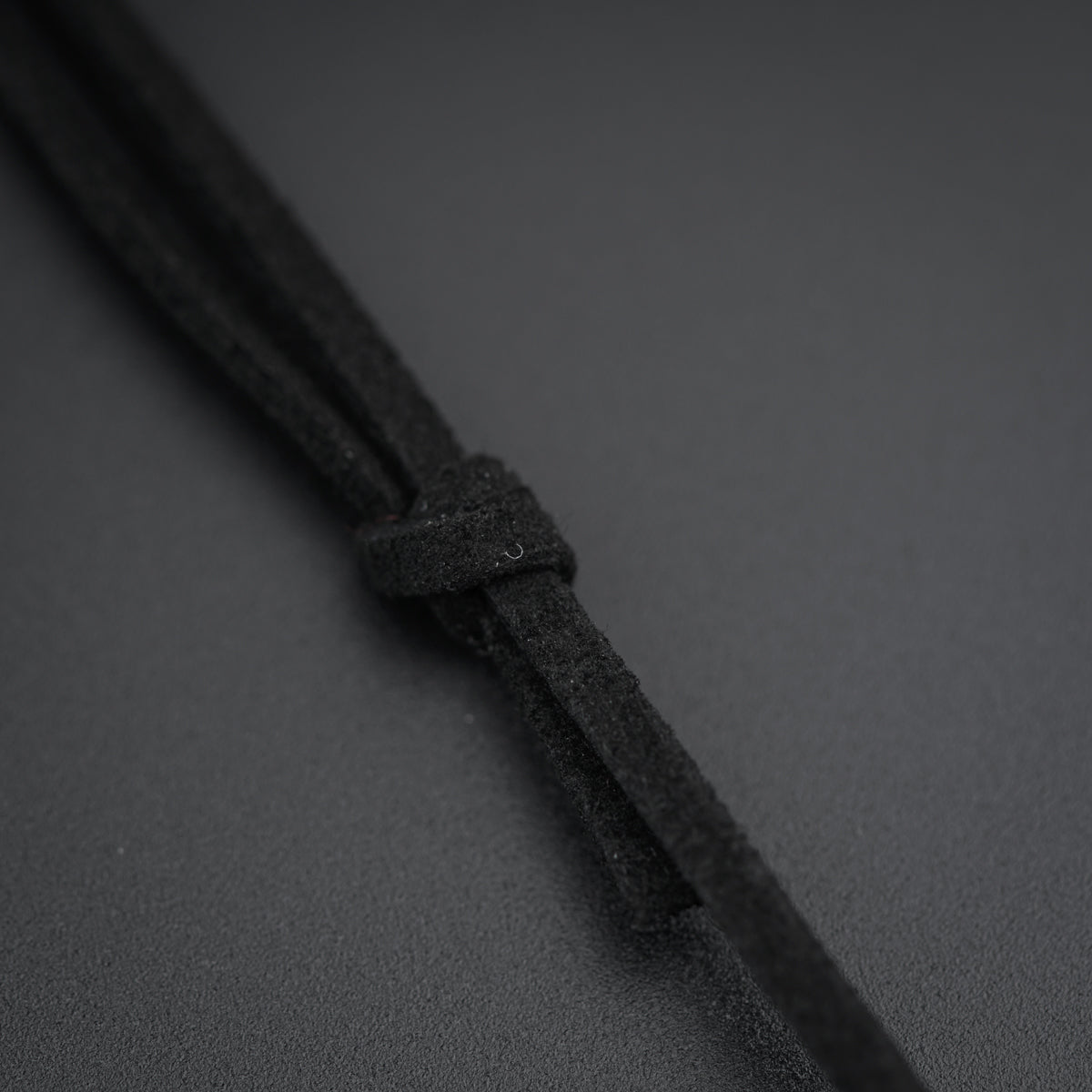 a close up of a black cord on a gray surface
