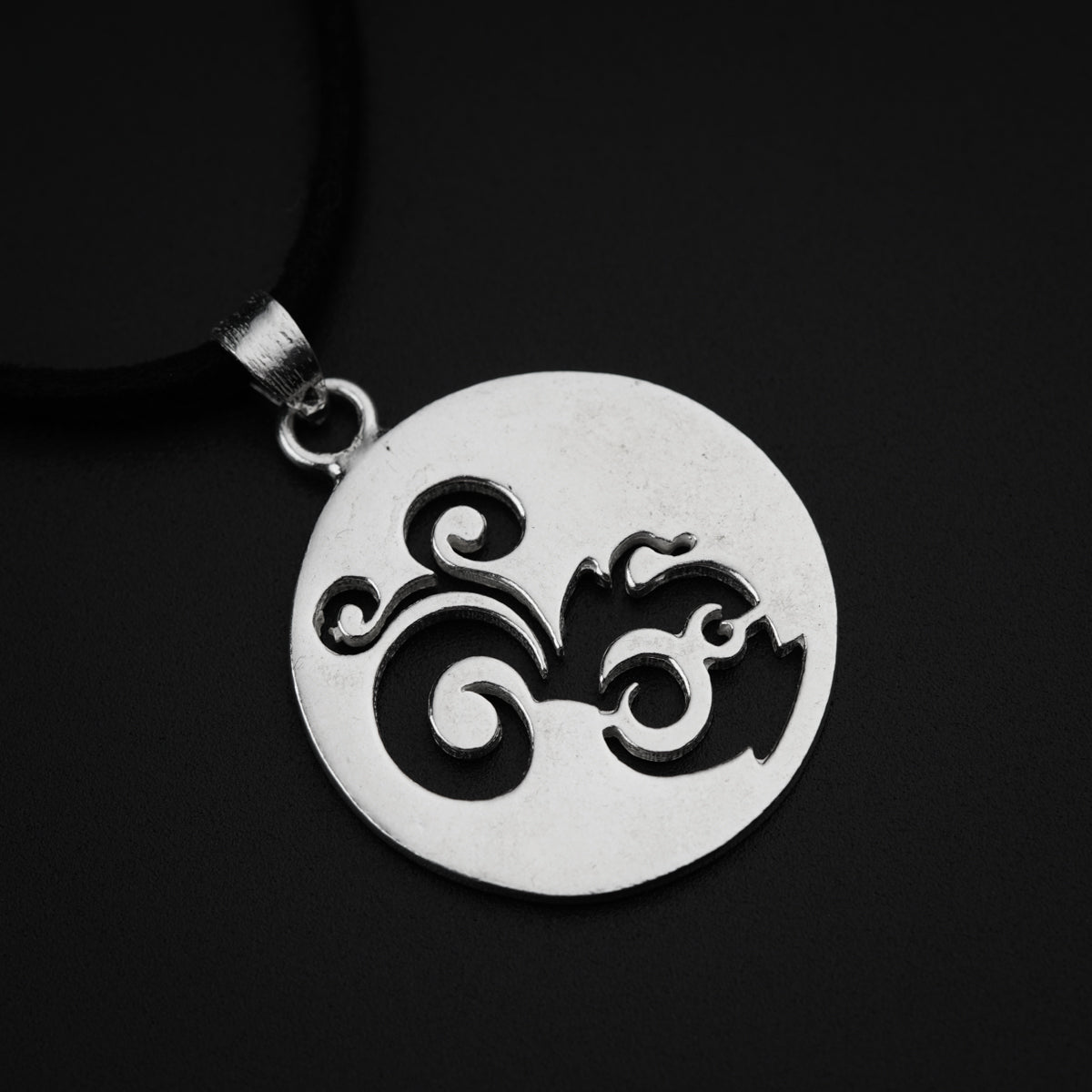 a pendant with a black and white design on it