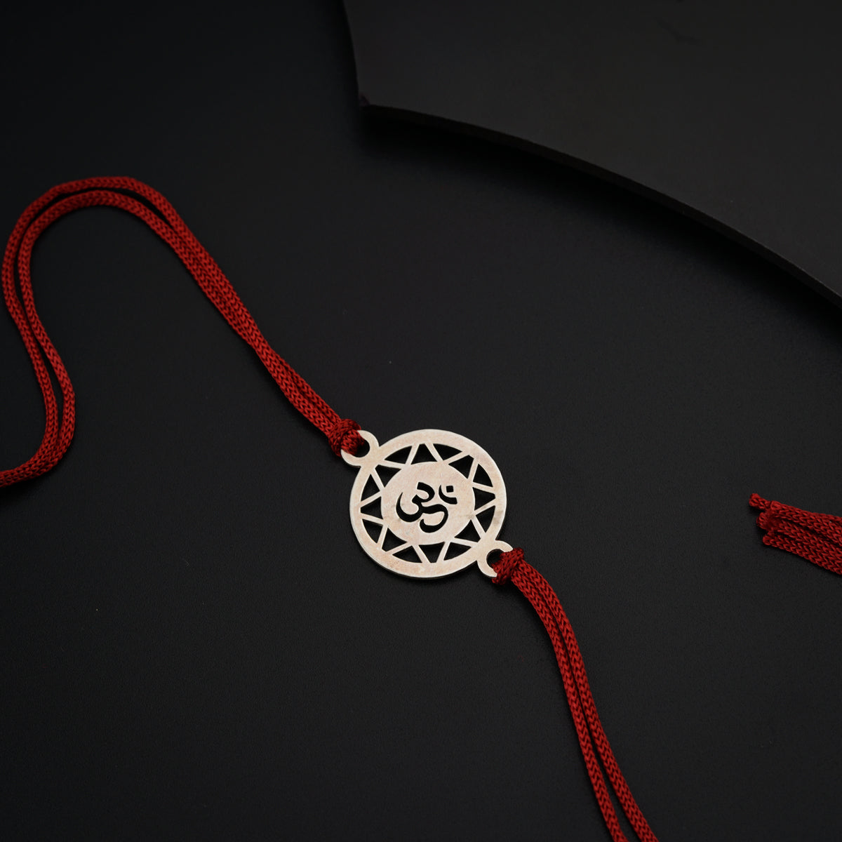 a red string with a white pendant on it