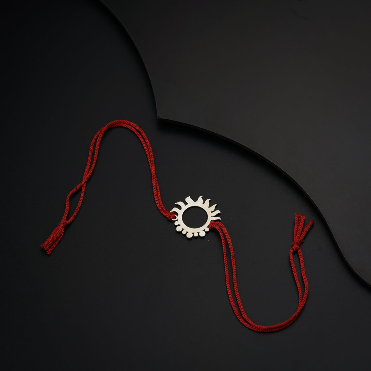 a red string with a white object on top of it
