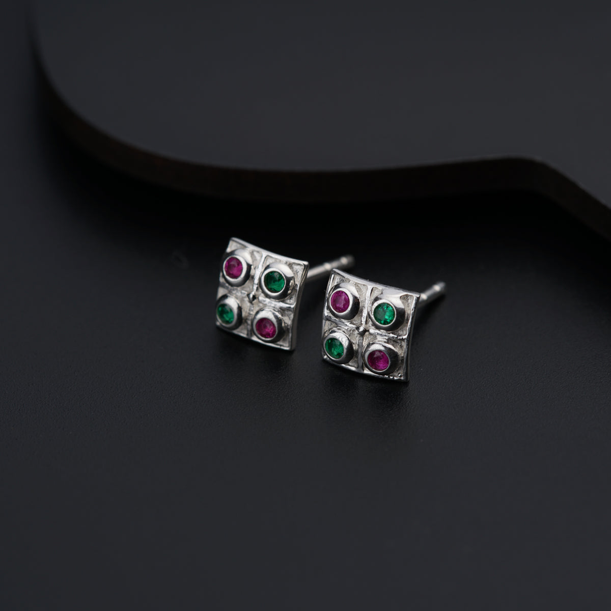 a pair of silver earrings with multi - colored stones