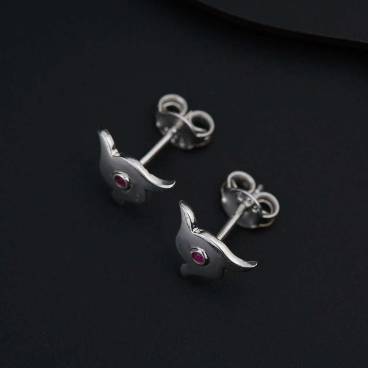 a pair of silver earrings with pink stones