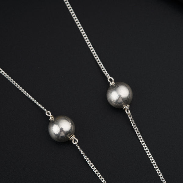a couple of silver balls sitting on top of a table