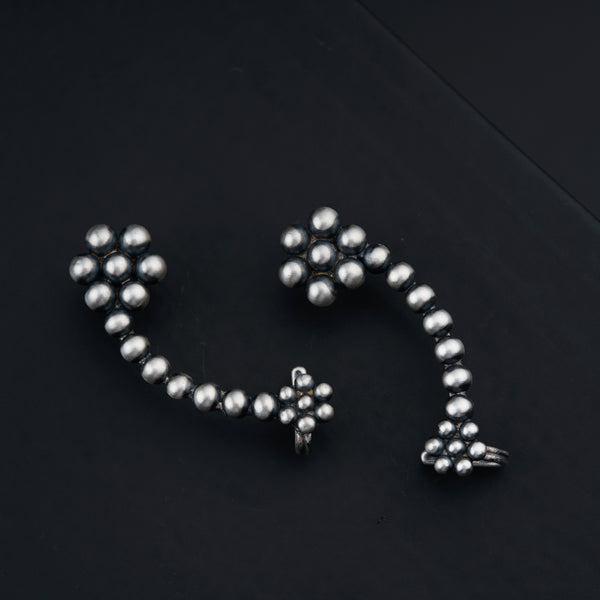 a close up of a metal object on a black surface