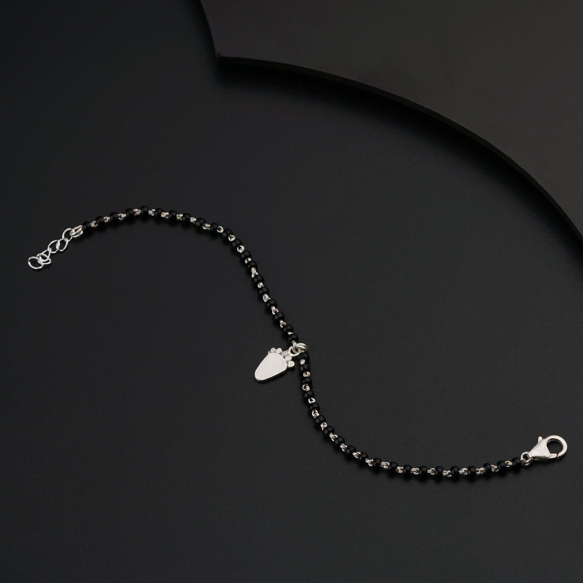 a black and silver necklace with a heart charm
