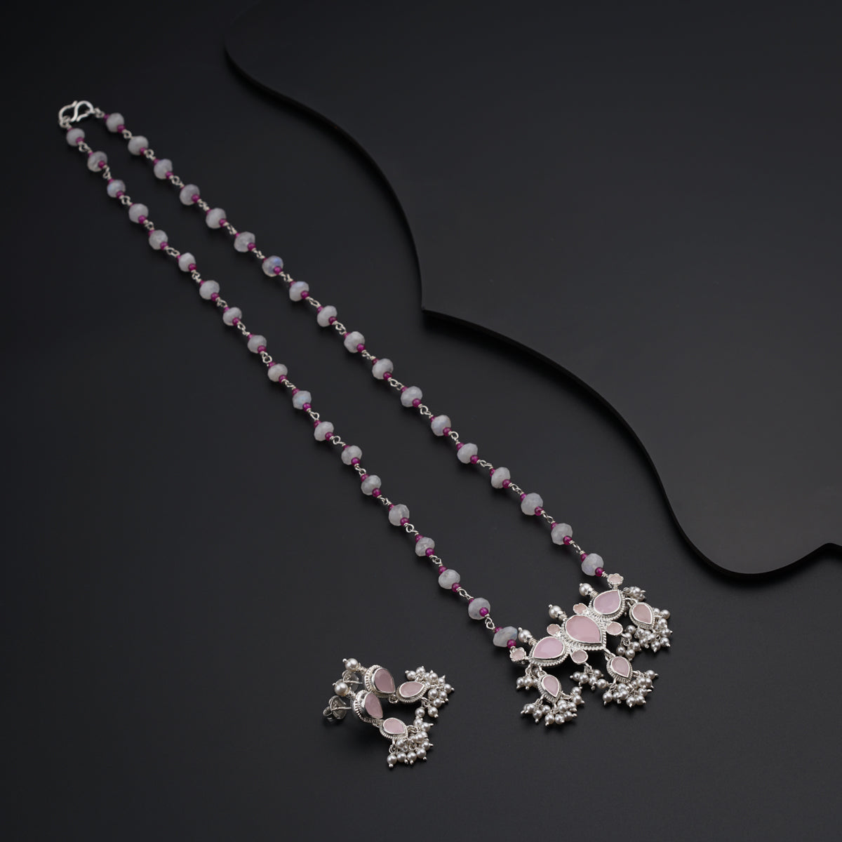 a necklace and earring set with pink beads