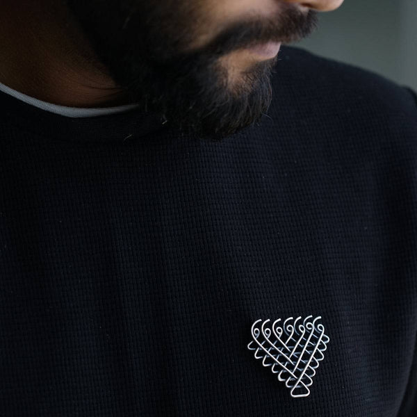 a man with a beard wearing a black shirt