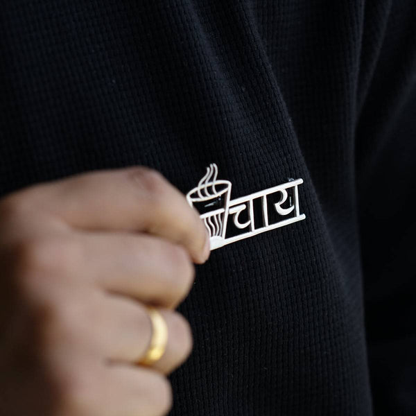 a person wearing a ring with a cup of coffee on it