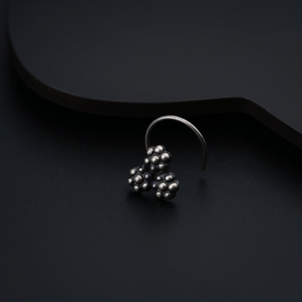 a close up of a metal object on a black surface
