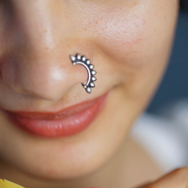 a close up of a person with a nose piercing