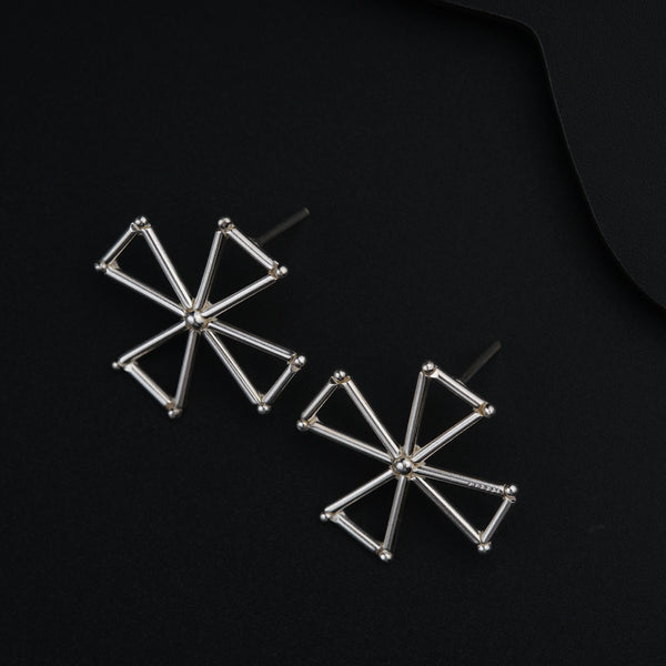 a pair of earrings on a black surface