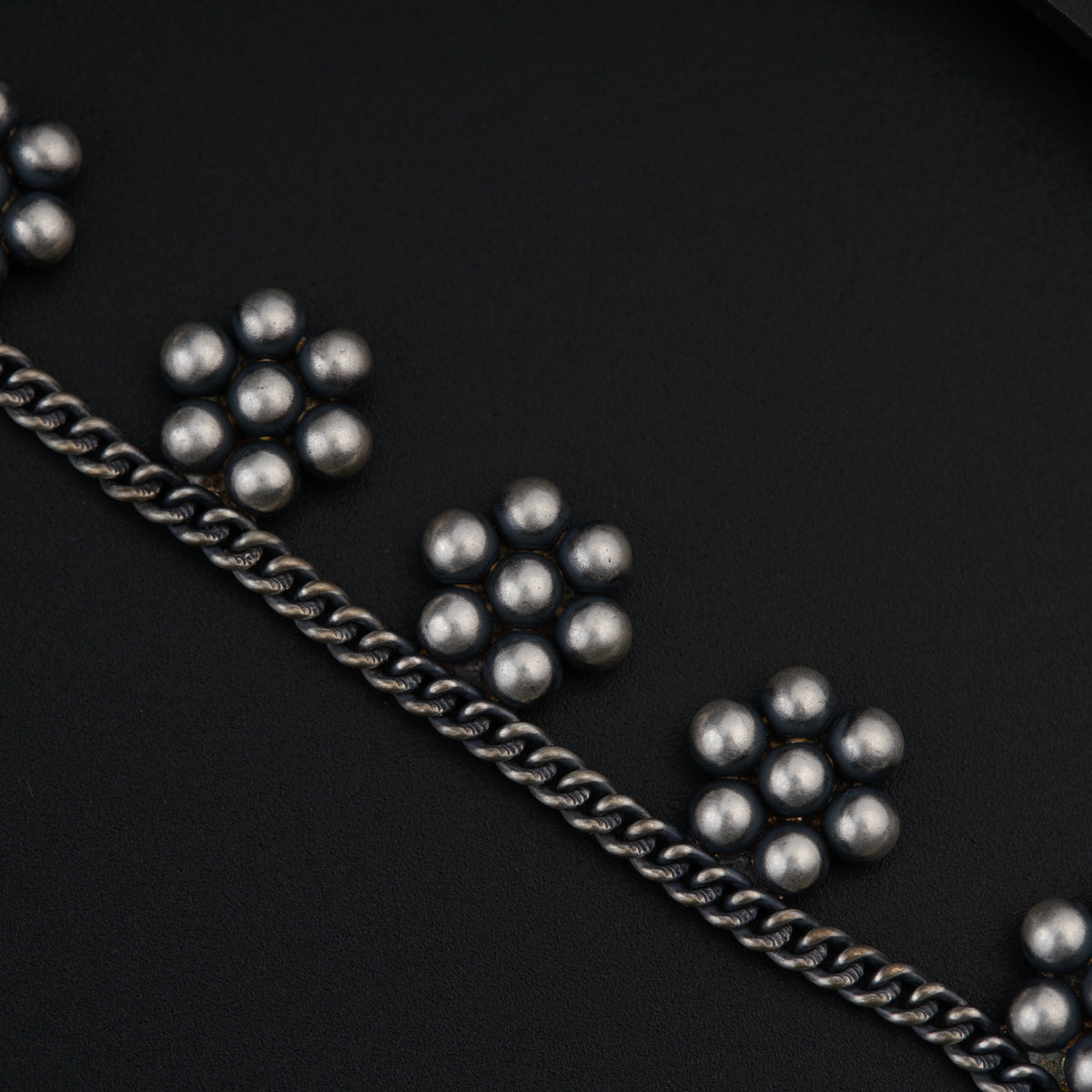 a bunch of balls and chains on a black surface