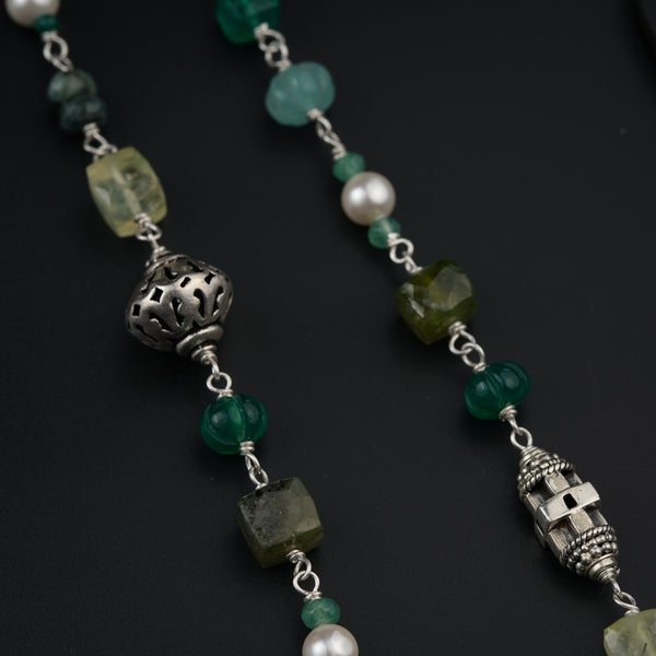 a long necklace with beads and charms
