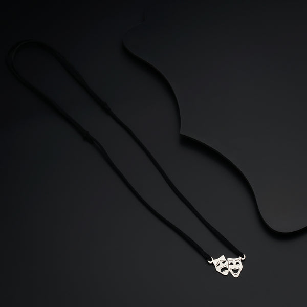 a necklace with a mask hanging from it