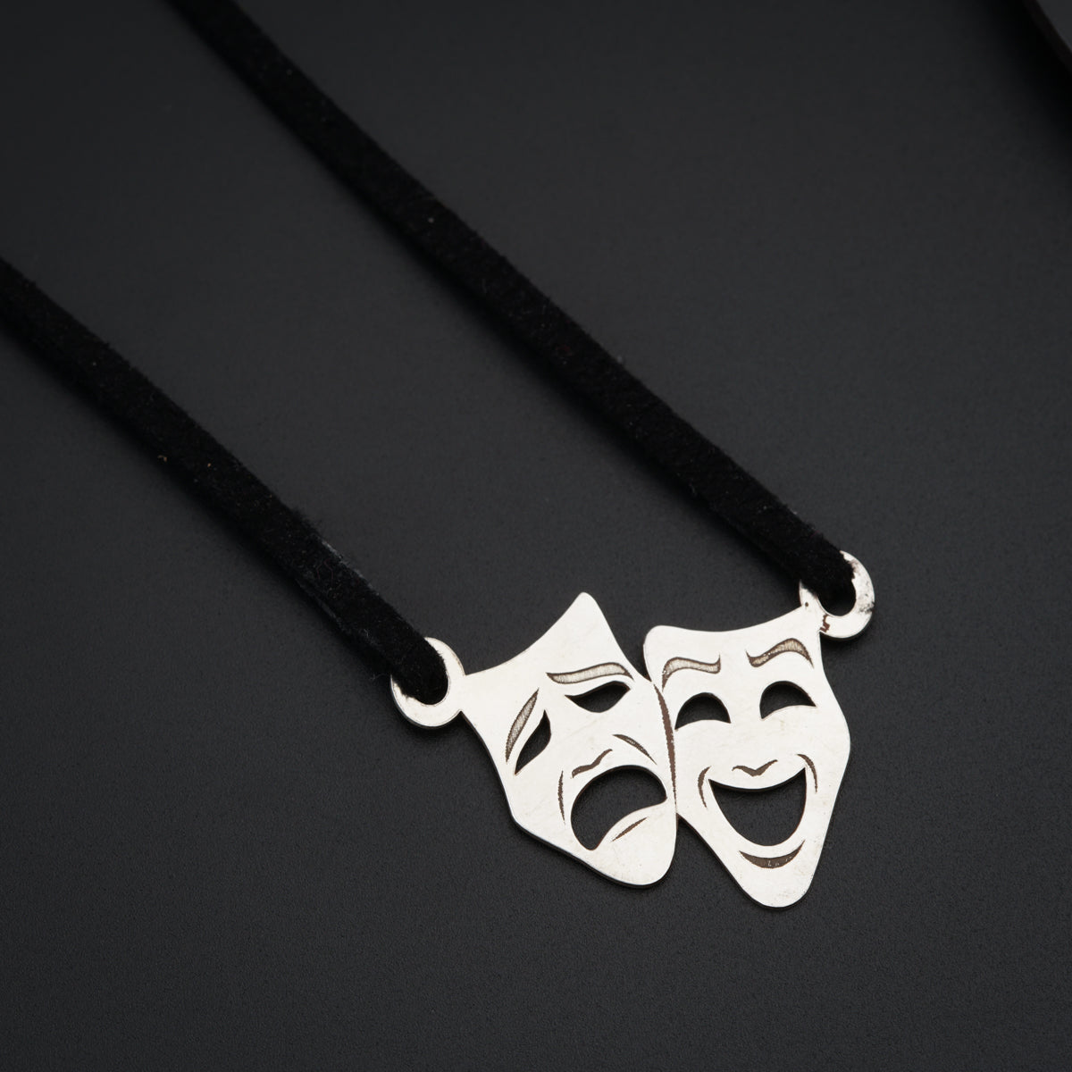 a couple of masks on a black cord