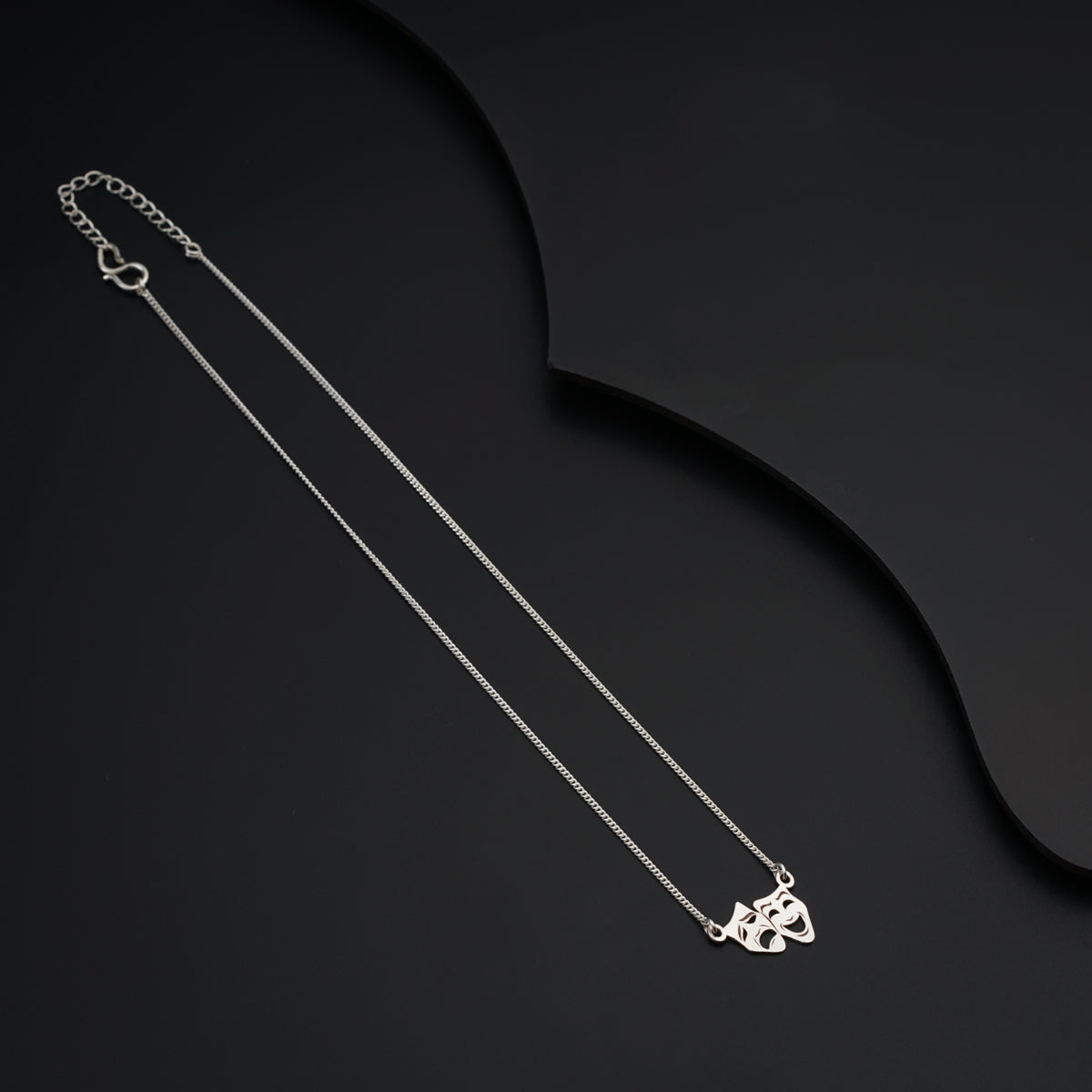 a silver necklace with a heart on it