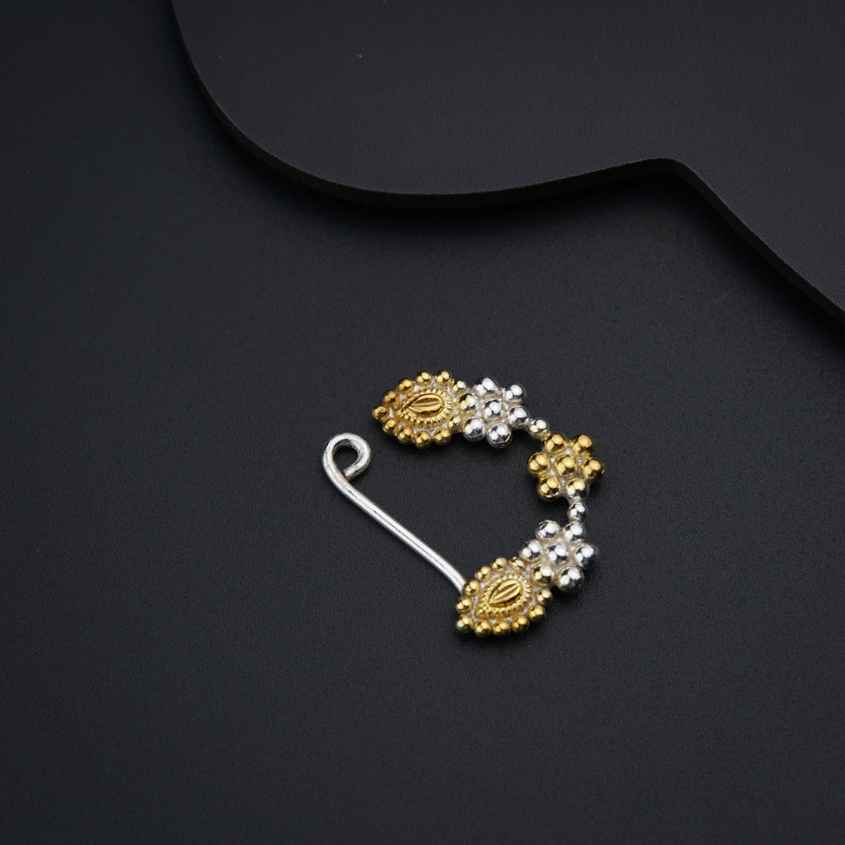 a pair of gold and diamond ear clips