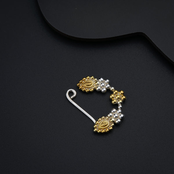 a pair of gold and silver earrings on a black background