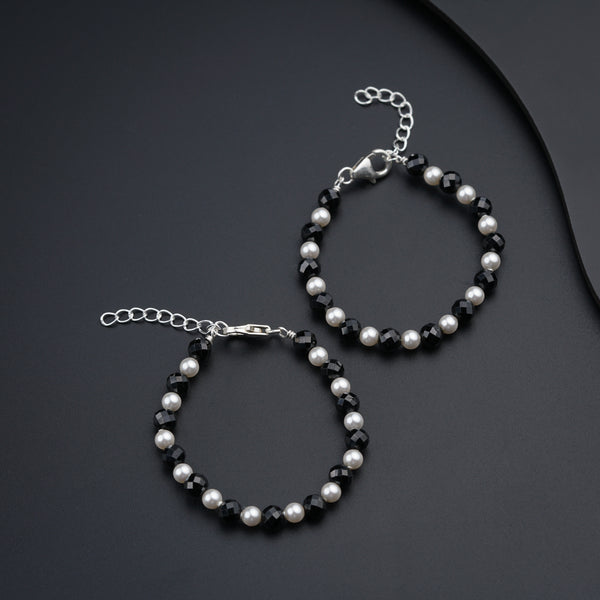a pair of black and white beaded bracelets