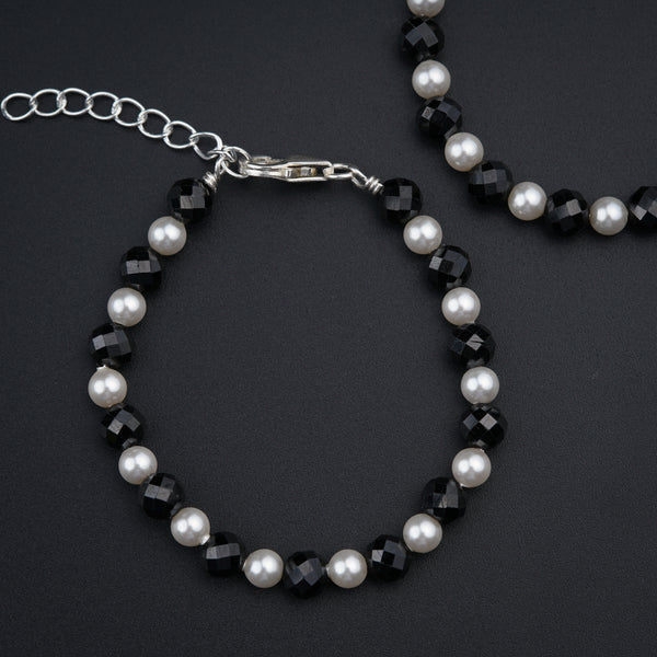 a close up of a bracelet and a necklace on a table