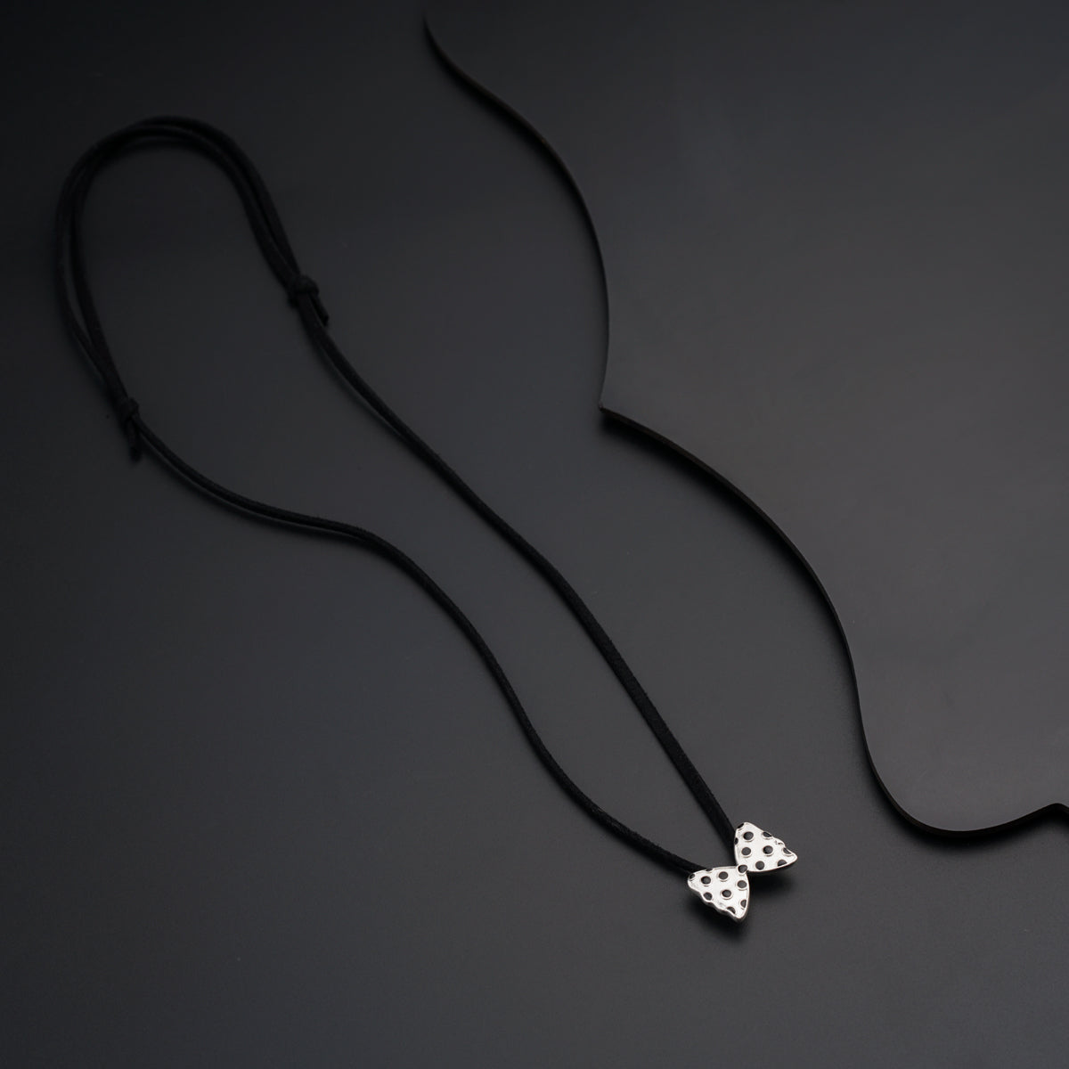 a black cord with a white flower on it