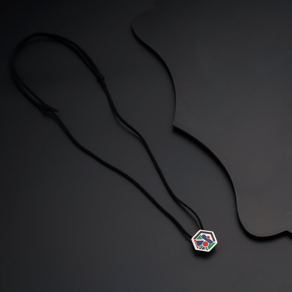 a black cord with a colorful pendant on it