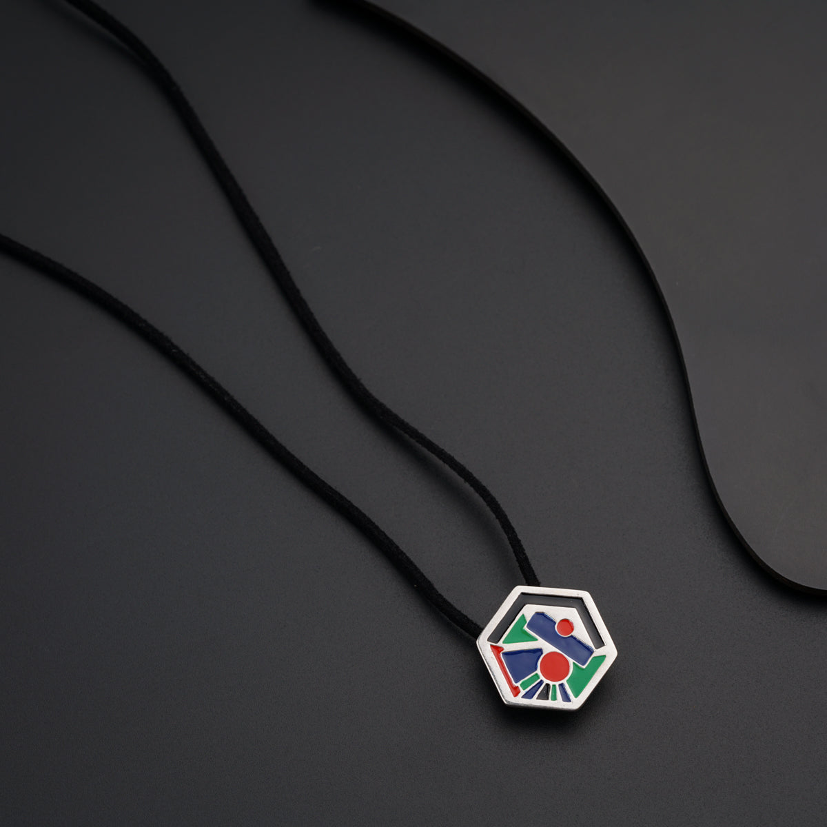 a necklace with a colorful design on a black background