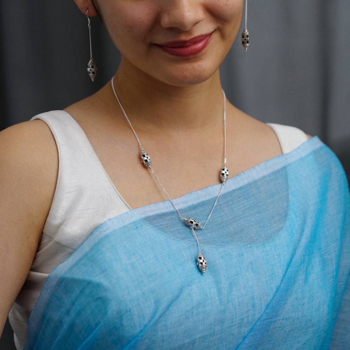 a woman wearing a blue and white sari
