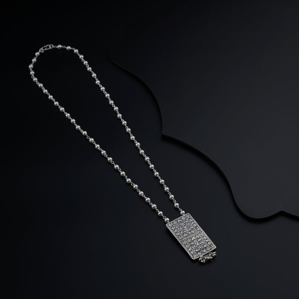 a silver necklace with a tag on it