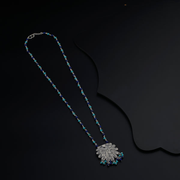 a long beaded necklace on a black background