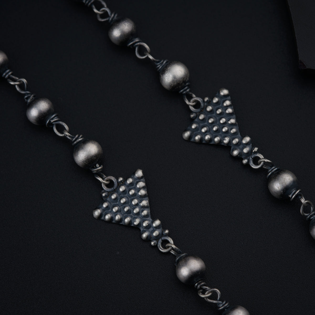 a close up of a necklace with a star on it