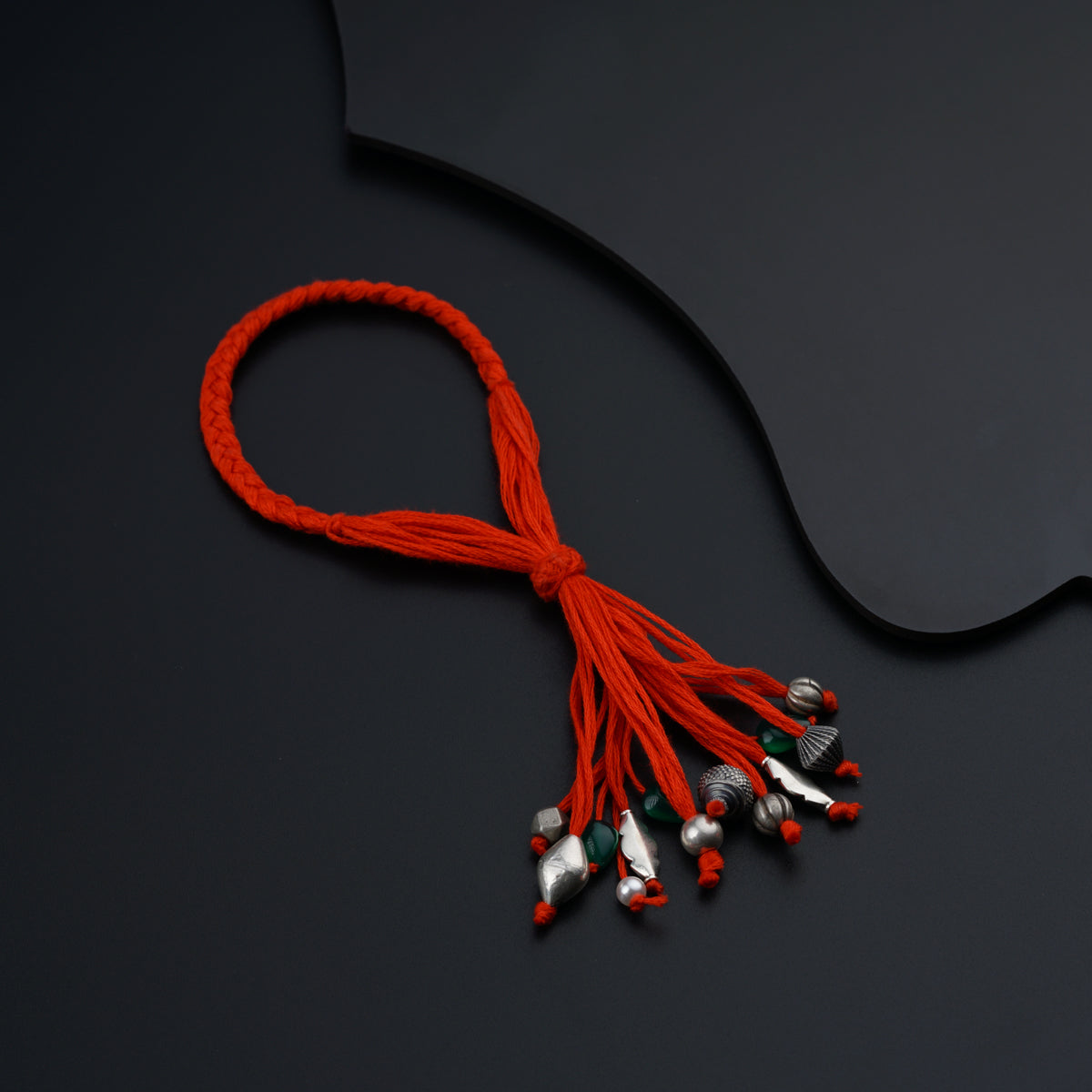 a red string with bells attached to it