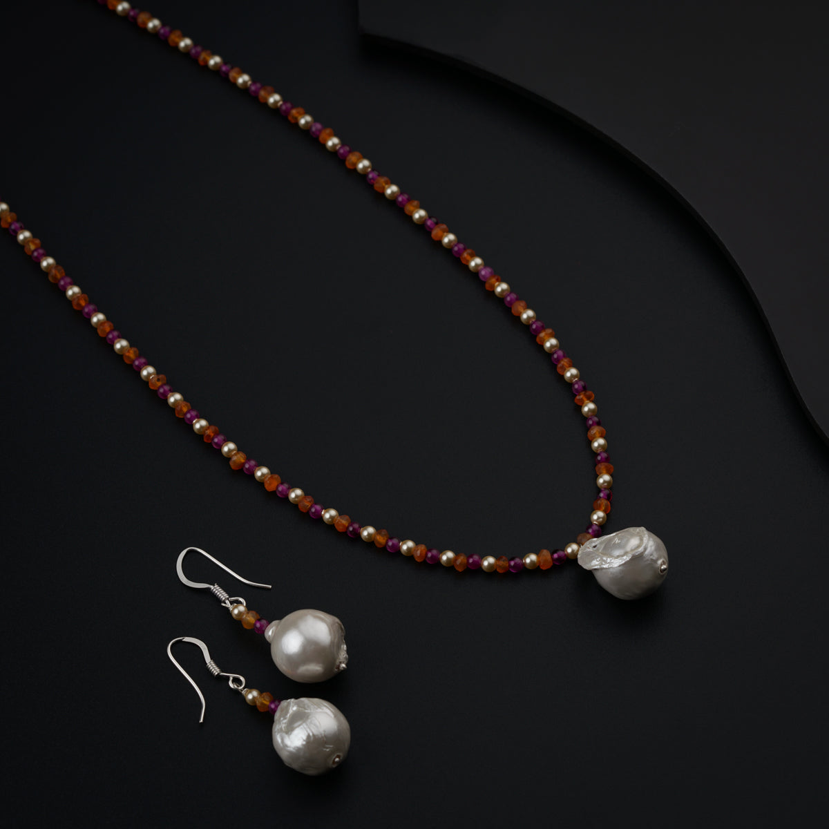 a necklace and earring set with pearls