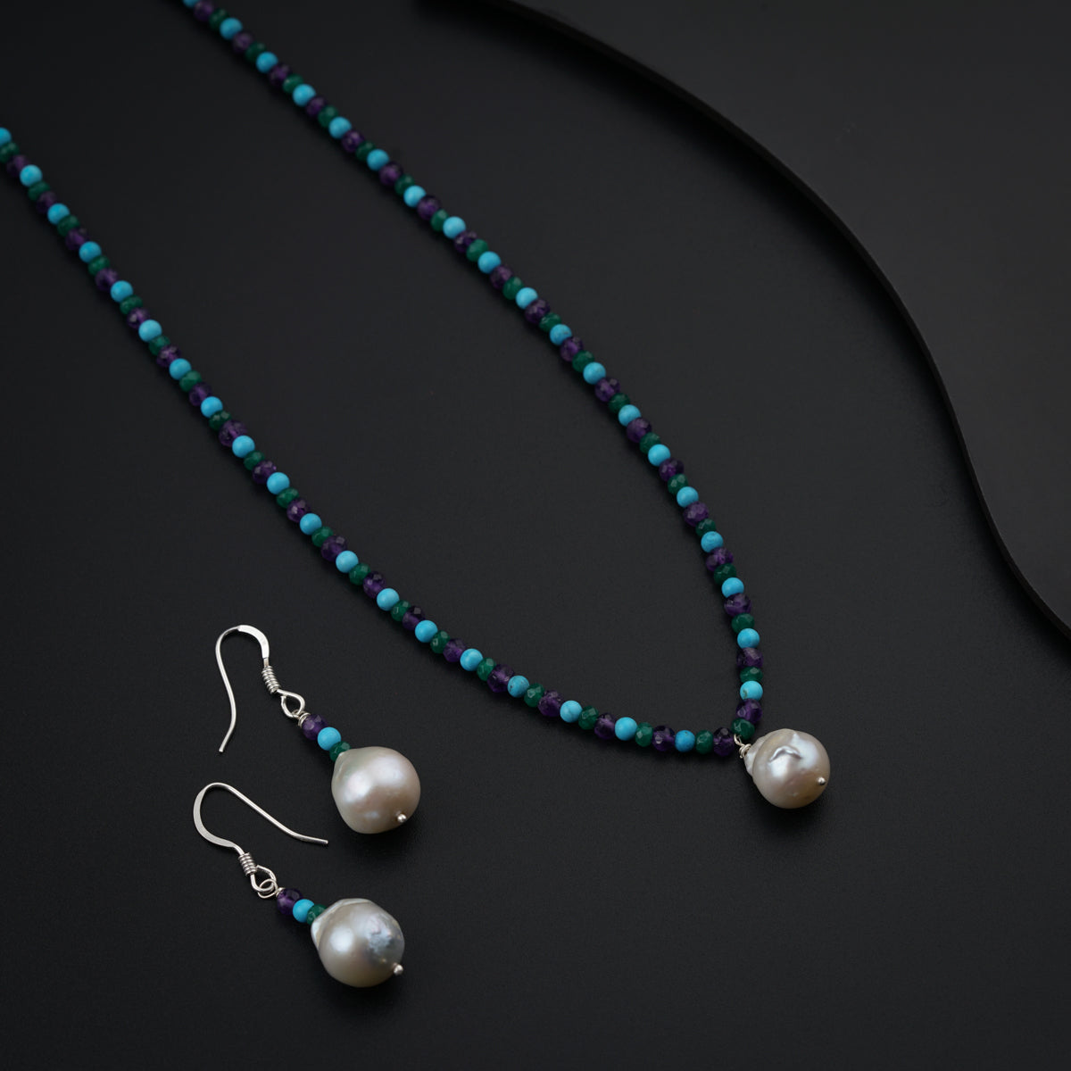 a necklace and earring set with pearls and turquoise beads