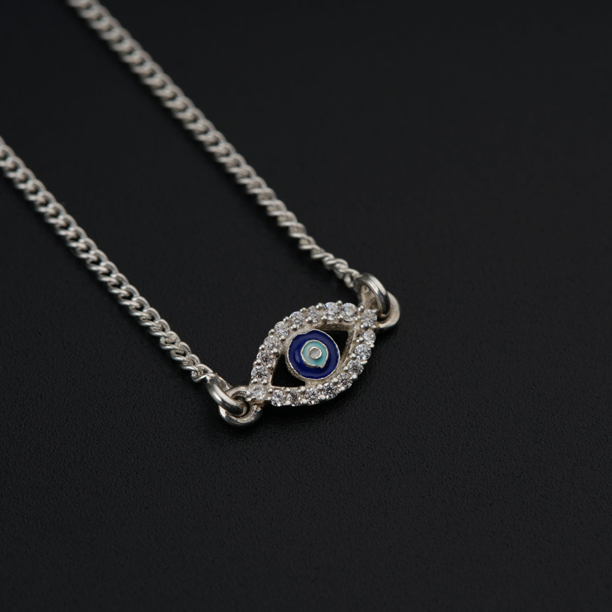 a blue evil eye necklace on a chain