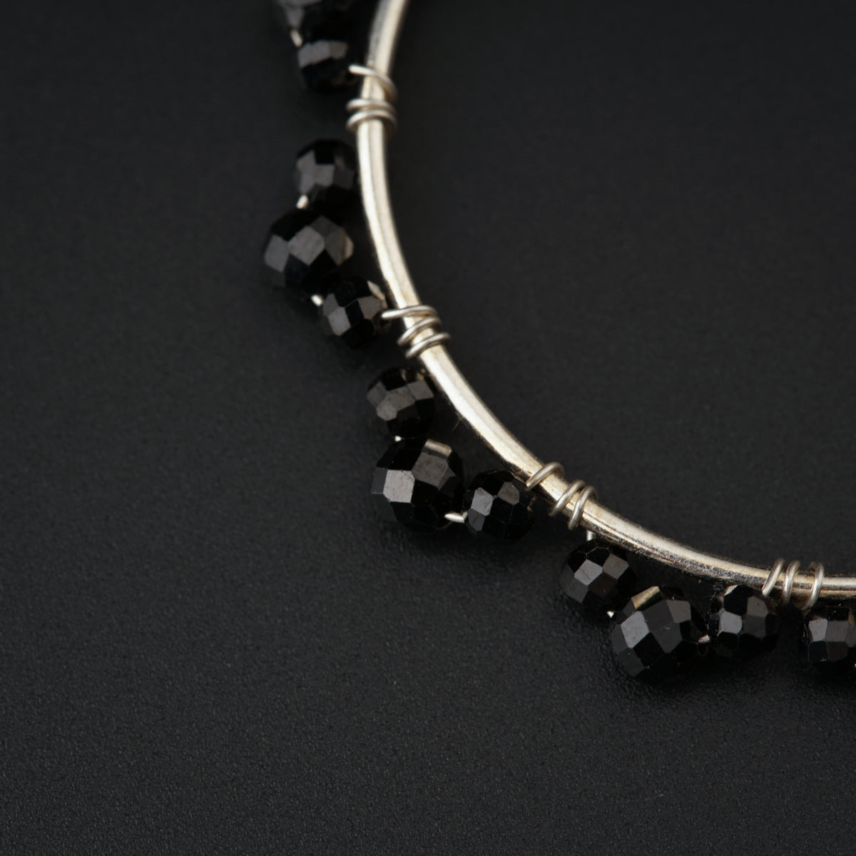 a close up of a necklace on a black surface