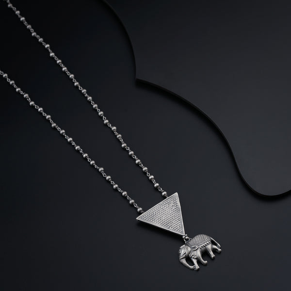 a necklace with an elephant and a triangle on it