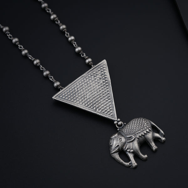 a silver necklace with an elephant on it