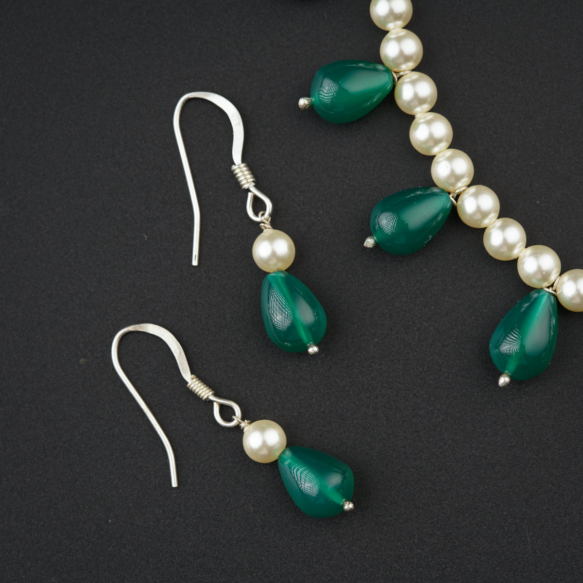 a pair of green glass and pearl earrings