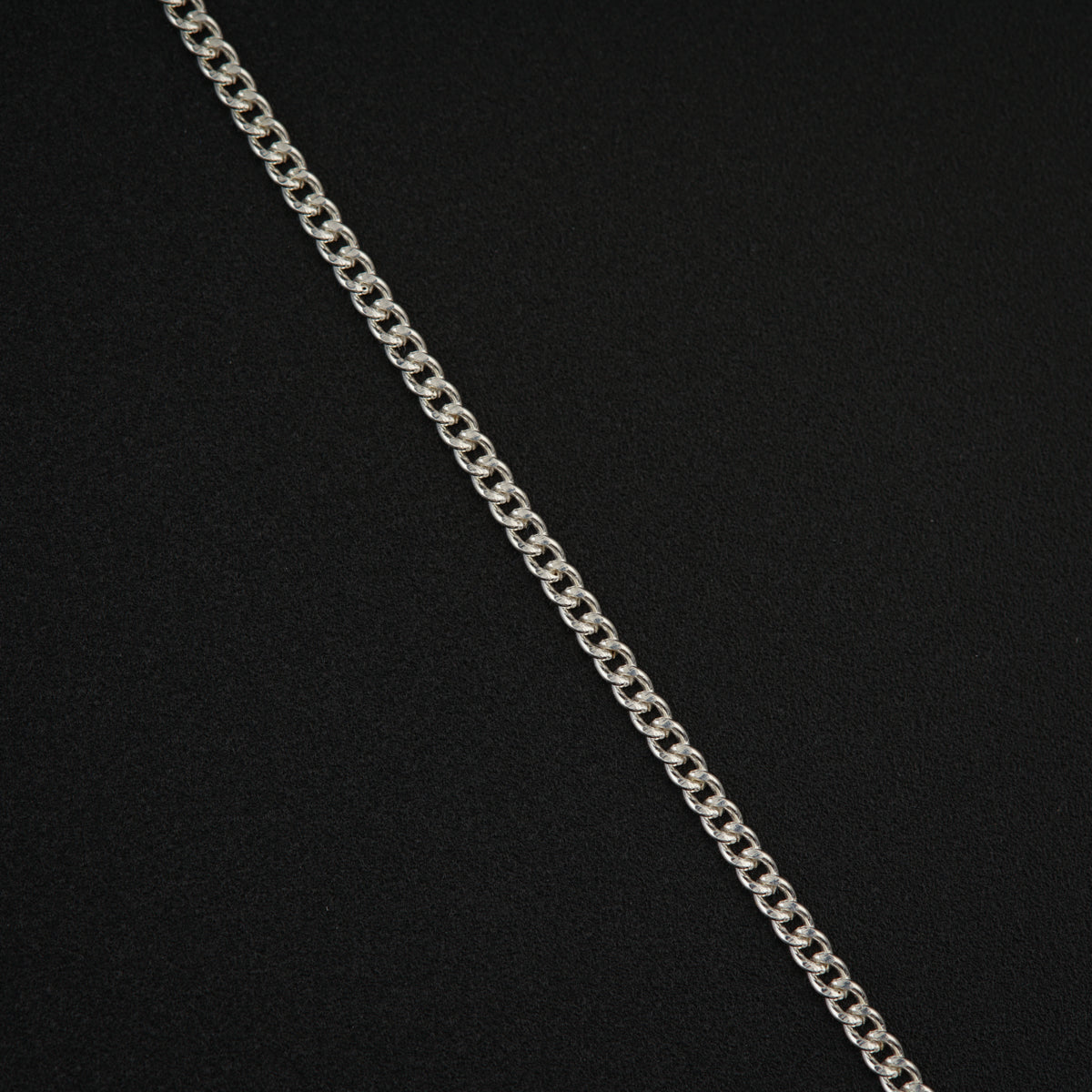 a silver chain with a black background
