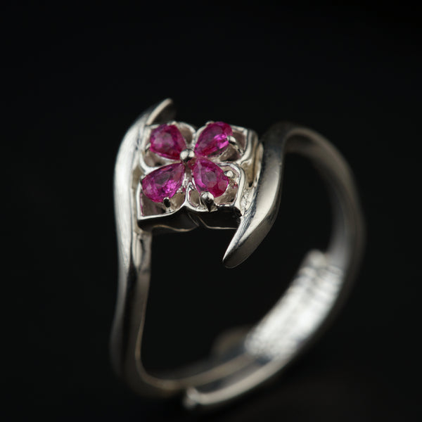 a close up of a ring with a flower on it