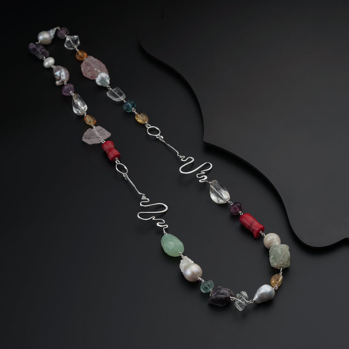 a long necklace with different colored beads
