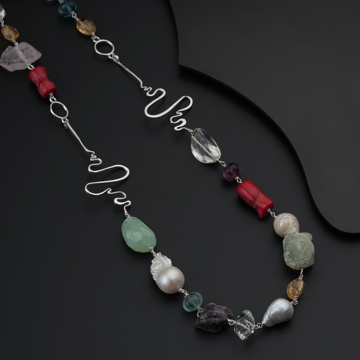 a long necklace with different colored beads