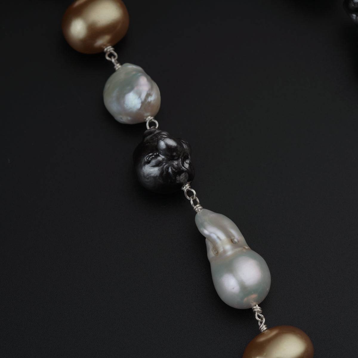 a black and white necklace with pearls on it