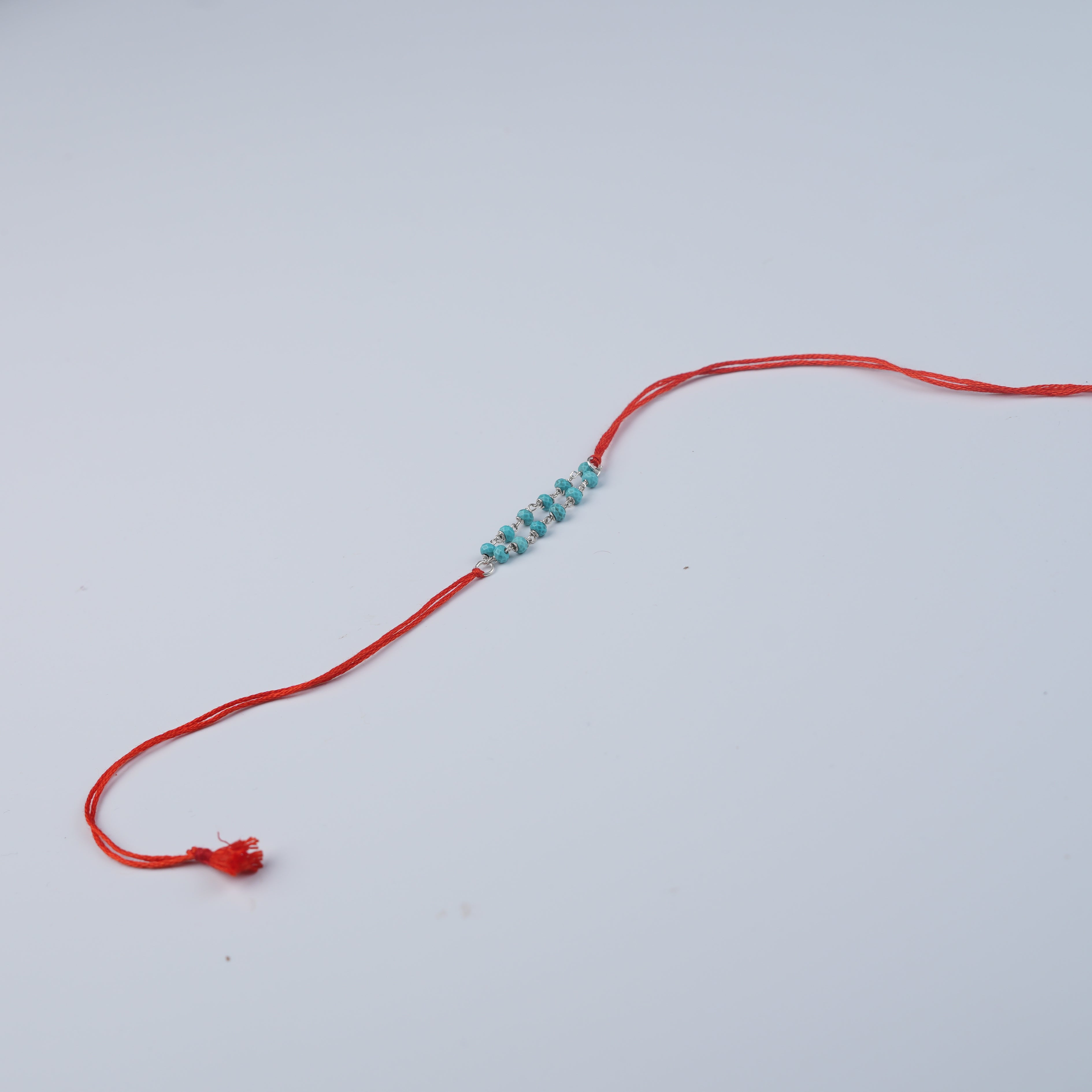 Turquoise Ganthan Rakhi (Project Handmade)