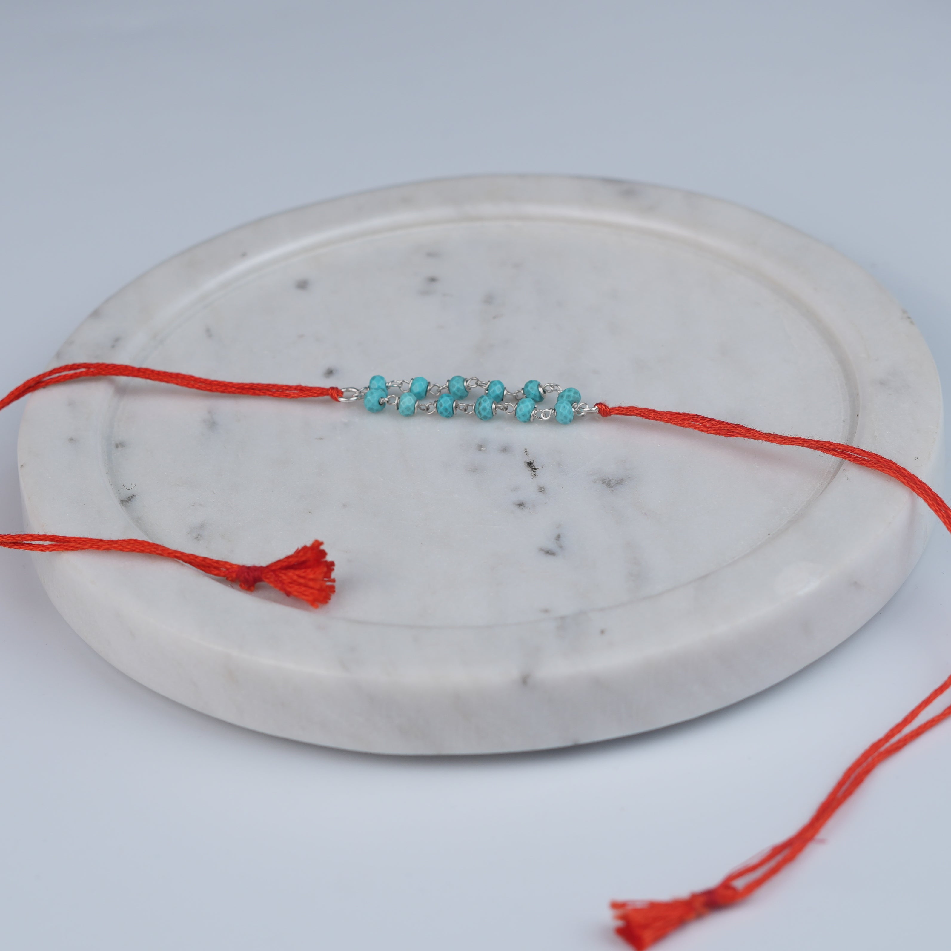 Turquoise Ganthan Rakhi (Project Handmade)